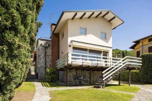 a house with a staircase in front of it at Villa Gardesana Torri del Benaco in Torri del Benaco