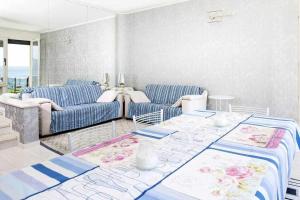 a living room with a couch and a table at Villa Gardesana Torri del Benaco in Torri del Benaco +20 photos