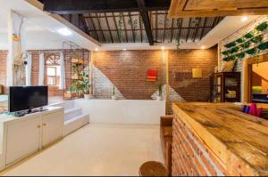 a large living room with a brick wall at Ahmad Lodge Garden View in Bandung