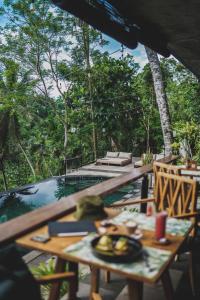 a table with a plate of food on it on a patio at Amora Ubud Boutique Villas in Ubud