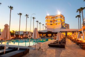 a hotel with a swimming pool and a building at Pavlo Napa Beach Hotel in Ayia Napa