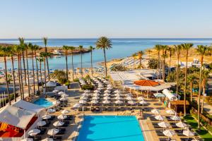 an aerial view of a resort with a pool and the ocean at Pavlo Napa Beach Hotel in Ayia Napa