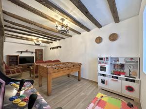 a room with a ping pong table and a kitchen at Casa Rural Sutegia in Ziga