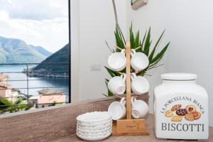 una mesa con una botella de leche y un jarrón en Appartamento Dany con vista lago, en Nesso