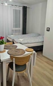 a room with two beds and a table and chairs at Route66 apartament by Karl in Radom