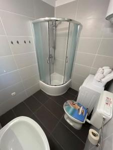 a bathroom with a shower and a toilet and a sink at BayStay in Kaštela +19 photos