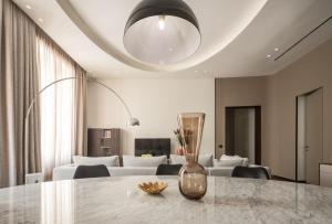 a living room with a table with a vase on it at Sant'Ambrogio Luxury Apartment R&R in Milan