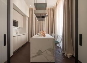 a kitchen with a white counter in a room at Sant'Ambrogio Luxury Apartment R&R in Milan