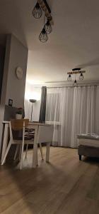 a living room with a dining room table and a ceiling at Route66 apartament by Karl in Radom