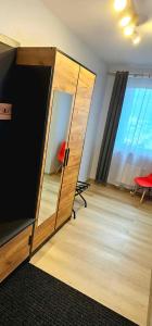 a room with a large mirror and a room with a table at Route66 apartament by Karl in Radom