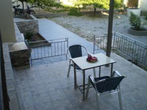 a table and two chairs on a patio at Matoula House in Vingláfia