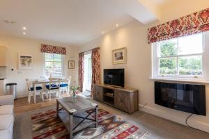 a living room with a flat screen tv and a table at The Applery, Leyburn Yorkshire Dales National Park in Leyburn