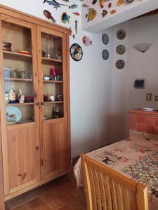 a room with a table and a cabinet with plates on the wall at Casa Marina Taormina in Taormina