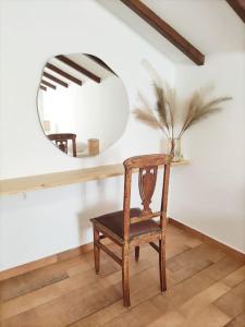 a mirror and a wooden chair in a room at Elektra Apartment-Kallithea in Kallithea Rhodes