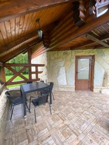 a patio with a table and chairs in a building at Sofiya in Mykulychyn