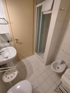 a white bathroom with a sink and a toilet at La Loggia Vicenza in Vicenza