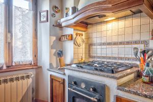 a kitchen with a stove and a counter top at Renaissance Apartment in Pienza