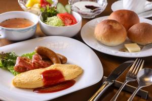 two plates of food on a table with food at Iroriyado Hidaya in Takayama