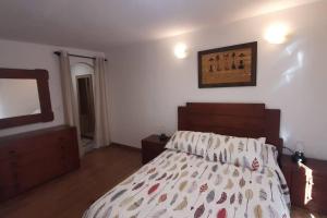 a bedroom with a bed and a mirror on the wall at Piso céntrico con encanto in Santander