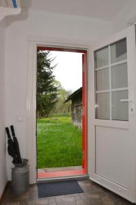 an open door with a view of a field at Садиба Злата хата in Urych