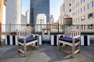 a pair of chairs sitting on top of a balcony at Midtown 2br w doorman wd nr Central Park NYC-1144 in New York