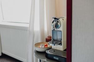 a kitchen mixer sitting on a table next to a window at sleepArt room for 3 in Celle