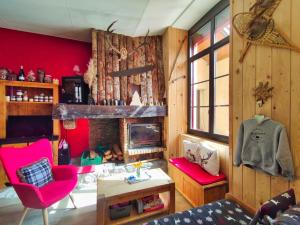 a living room with a fireplace and red walls at Le sapin rouge, chambres d'hôtes - restaurant - bar in Artigues