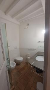 een witte badkamer met een toilet en een wastafel bij Casa vacanze Iris in Todi