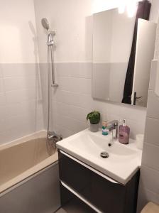 a white bathroom with a sink and a shower at Charmant studio climatisé 24 m2 terrasse à 100m de la plage in Saint-Mandrier-sur-Mer