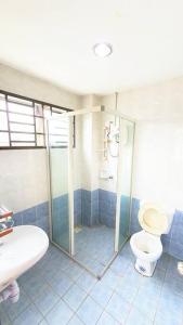 a bathroom with a shower and a toilet and a sink at Puchong Semi D Homestay spacious 4 rooms in Puchong