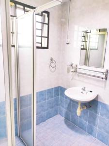 a bathroom with a sink and a shower at Puchong Semi D Homestay spacious 4 rooms in Puchong