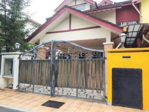 a gate in front of a house at Puchong Semi D Homestay spacious 4 rooms in Puchong