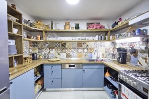 a kitchen with blue cabinets and wooden shelves at Holiday house with a parking space Krapina, Zagorje - 21000 in Krapina