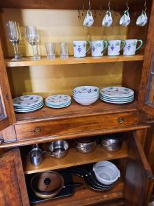 a cabinet filled with plates and bowls and glasses at Panoramico nell'antico borgo medievale di Casperia in Casperia