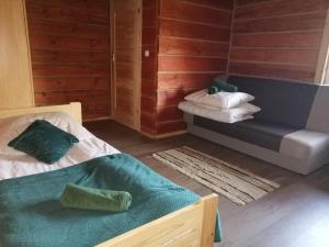 a room with two beds and a couch at Radawa Family Space in Radawa