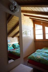 a mirror in a room with two beds in it at Vue à couper le souffle Arellaz 42 in Zinal