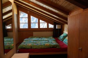 a bedroom with a bed in a small room at Vue à couper le souffle Arellaz 42 in Zinal