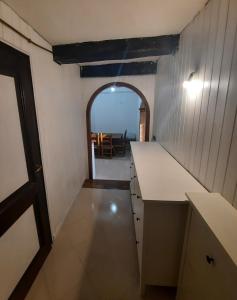 a kitchen with an archway and a table in the background at Panoramico nell'antico borgo medievale di Casperia in Casperia