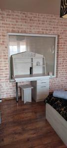 a white desk in a room with a brick wall at Hostel Texas in Suwałki