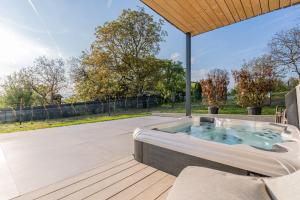 a hot tub on the patio of a house at Lind Fruchtreich in Sebersdorf