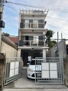 a white car parked in front of a house at Block 7 Dormitelle - Balanga City in Balanga