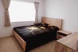 a bedroom with a bed and a window at House Located at the centre of East Auckland walking to Botany Westfield Shopping Mall in Auckland