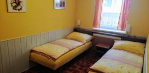 Postel nebo postele na pokoji v ubytování penzion U Soudu