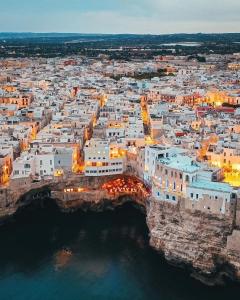 an aerial view of a city at night at Alba b&b in Polignano a Mare