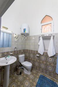 y baño con aseo y lavamanos. en Feruzkhan Hotel - Madrassah Mohammed Rakhim Khan 1871, en Khiva
