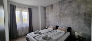 a bedroom with a large bed and a large window at Apartments Miočić in Zadar