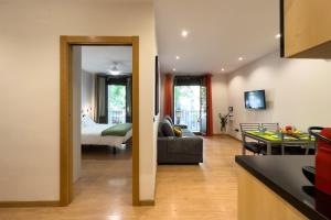 a kitchen and a living room with a bedroom at Stay Barcelona Sant Antoni in Barcelona