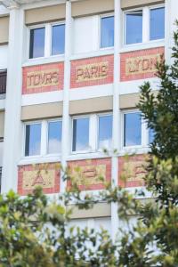 a tall white building with the names of the parkscriptions on it at * Spa & Détente # Suite Privée # Tours # Netflix * in Tours