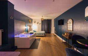 a hotel room with a tub and a bed at * Spa & Détente # Suite Privée # Tours # Netflix * in Tours