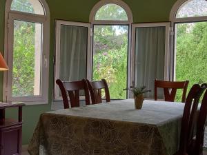 a dining room with a table with chairs and windows at Villa Alemania in Altea